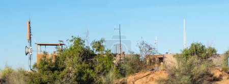 Photo for Vervet monkeys are visible at a water reservoir, cell phone base station and telecommunications equipmet in Augrabies Falls National Park - Royalty Free Image