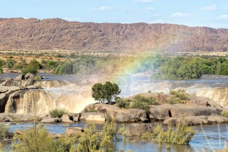Photo for A rainbow at the Augrabies Waterfall in the flooded Orange River. - Royalty Free Image