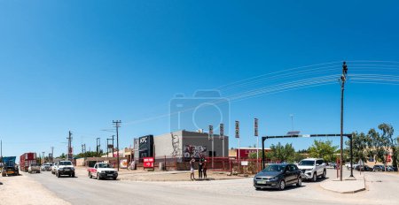 Photo for Douglas, South Africa - Mar 1, 2023: A street scene, with a shopping centre, people and vehicles, in Douglas in the Northern Cape Province - Royalty Free Image