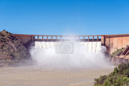 Photo for The Vanderkloof Dam overflowing seen from bridge below the dam wall. It is the second largest dam in South Africa. It has the tallest dam wall in South Africa - Royalty Free Image