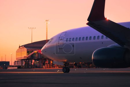 Foto de Avión durante el rodaje a pista para despegar. Tráfico en el aeropuerto al amanecer. Temas viajes, vacaciones y aviación - Imagen libre de derechos
