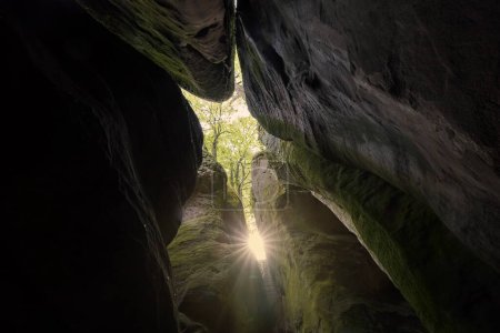 Photo for Sunbeams between natural stone columns in sandstone rocks. Tranquility in Hruba Skala in Bohemian Paradise, Czech Republic - Royalty Free Image
