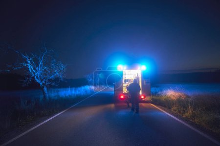 Photo for Paramedic in blurred motion is pulling stretcher with patient to ambulance car of emergency medical service. Themes rescue, urgency and health care. - Royalty Free Image