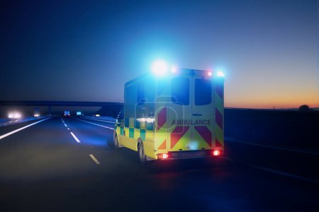Photo for Fast moving ambulance car of emergency medical service on highway at night. Themes healthcare, rescue and urgency - Royalty Free Image