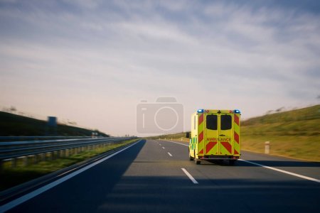 Photo for Fast moving ambulance car of emergency medical service on highway. Themes healthcare, rescue and urgency - Royalty Free Image