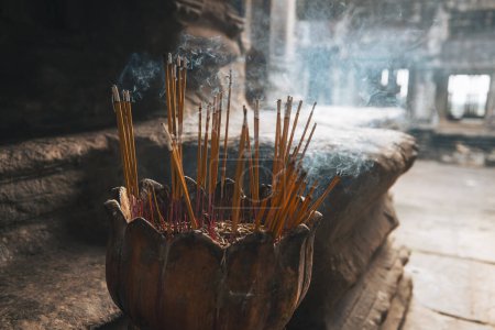 Photo for Incense sticks burning with smoke in ancient temple in Cambodia - Royalty Free Image