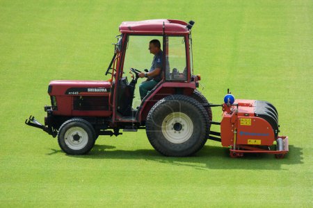 Photo for LUBIN, POLAND - SEPTEMBER 9, 2021: Man in tractor aerating a soccer field - Royalty Free Image