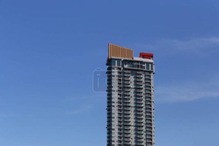 Top of a tall building with a blue sky background at daytime and copy space for design in your work concept.