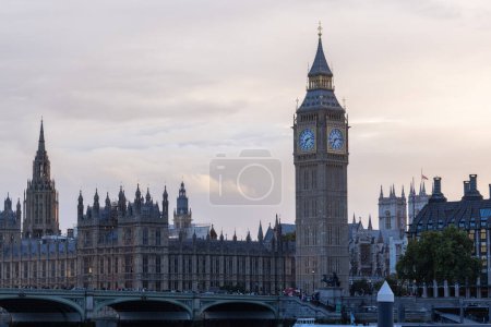 Photo for Palace of Westminster with its distinctive Tower of Big Ben at sunset and beautiful coloured sky, handheld shot. - Royalty Free Image
