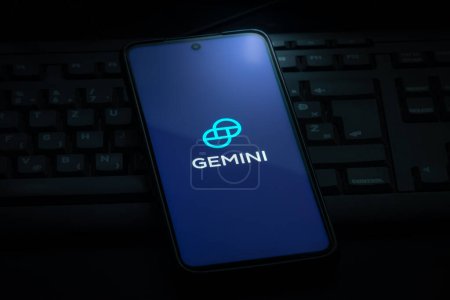 Photo for Ljubljana, Slovenia - 21 January 2023: Gemini crypto exchange logo on smartphone screen laying on computer keyboard - Royalty Free Image