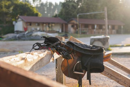 Photo for Horse saddle with stirrups on a farm outside, close up - Royalty Free Image
