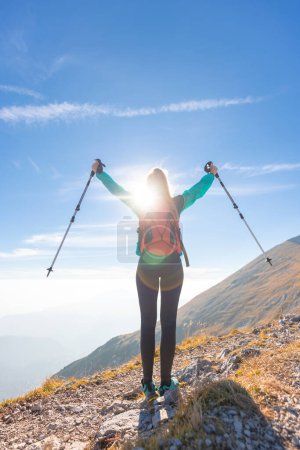 Photo for Happy young hiker woman with raised arms in the mountains in autumn - Royalty Free Image