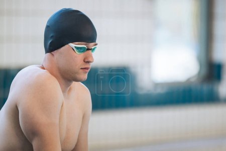 Photo for Male swimmer jumping off the starting block into the pool. Concept of determination and competitive sport. - Royalty Free Image