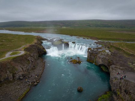 Fantastic shot of the Godafoss waterfall in Iceland and its incredible surroundings, aerial view. Tourist attraction and natural beauty concepts.