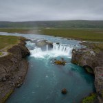 Fantastic shot of the Godafoss waterfall in Iceland and its incredible surroundings, aerial view. Tourist attraction and natural beauty concepts.