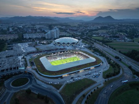Spectacular scenery of the football stadium in Ljubljana, Slovenia at sunset, drone shot. Nature and modern architecture concepts.
