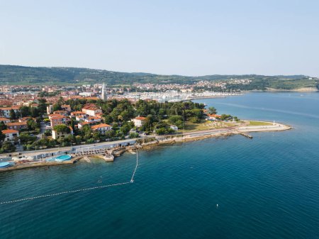 Old fishing town Izola in Slovenia on the Adriatic sea coast, with beautiful seascape and marina, aerial shot. Travel, tourism, and vacation concepts.