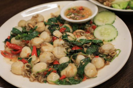 Foto de Vieira frita picante mezclada con una variedad de hierbas tailandesas como jengibre, chile, pimienta, galingala. Comida tailandesa llamada "Pad Cha Hoi Shell" - Imagen libre de derechos