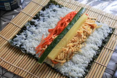 Téléchargez les photos : Rouleau de gimbab à base de riz blanc cuit à la vapeur et de divers autres ingrédients, roulé. Cuisine de rue coréenne. - en image libre de droit