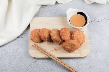 Deep fried shrimp cake with sweet plum sauce. Tod Tod Mun Kung Asian food, made from ground shrimp and other ingredients before rolling in flour, egg and bread crumbs and deep fried.