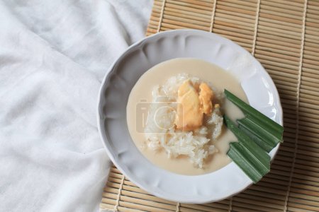 Sticky rice with durian in coconut milk. Asian Thai dessert summer tropical fruit food. Khao Nieow Nam Kati Durian