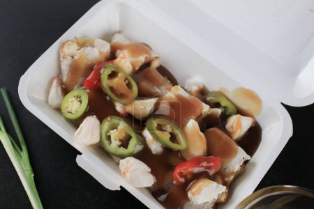 Frische Frühlingsrollen mit Krabben darauf und süßer Sauce auf schwarzem Tisch. Asiatisches Essen thailändischen Stil Seitenansicht. Konzept für gesunde Ernährung.