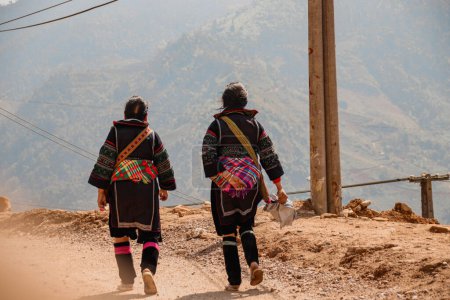 Téléchargez les photos : Les femmes de la tribu Hmong portant leurs vêtements traditionnels tout en marchant vers le village de Lao Cai à Sa pa, Vietnam - en image libre de droit
