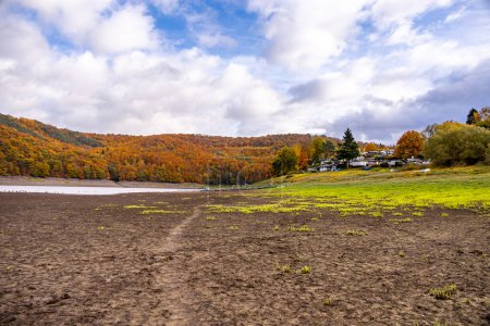Photo for Autumn hike along the Eder dam to the sunken city of Lake Eder Atlantis - Edertal - Hesse - Germany - Royalty Free Image
