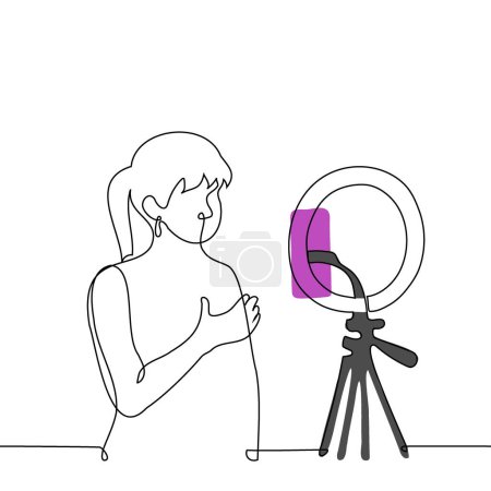 Woman broadcasts while standing in front of a phone camera mounted on a ring lamp - one line art vector. concept live stream of a female blogger