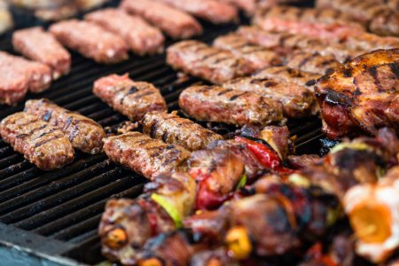 Photo for Grilling tasty food on barbecue. Steak, sausages on grill at food festival - Royalty Free Image