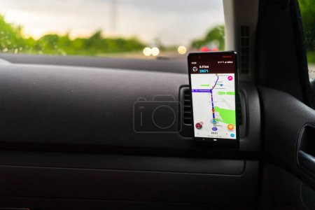 Photo for Using waze maps application on smartphone on car dashboard, Bucharest, Romania, 2023 - Royalty Free Image