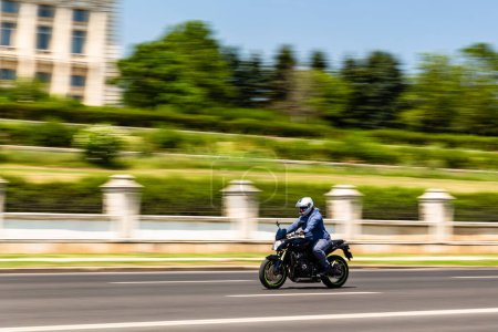 Photo for Biker on a motorcycle in traffic at rush hour in downtown area of the city in Bucharest, Romania, 2022 - Royalty Free Image