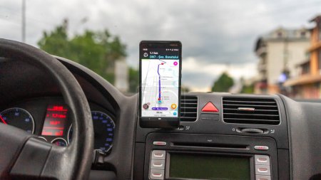 Photo for Smartphone showing Waze maps to show the way thru the city. Driver using Waze maps - Royalty Free Image