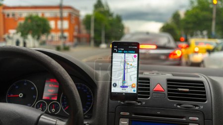 Photo for Smartphone showing Waze maps to show the way thru the city. Driver using Waze maps - Royalty Free Image