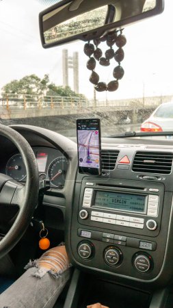Photo for Waze maps showing the way thru the city. Driver using Waze maps - Royalty Free Image