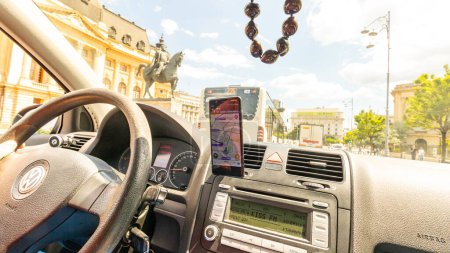 Photo for Waze maps showing the way thru the city. Driver using Waze maps - Royalty Free Image