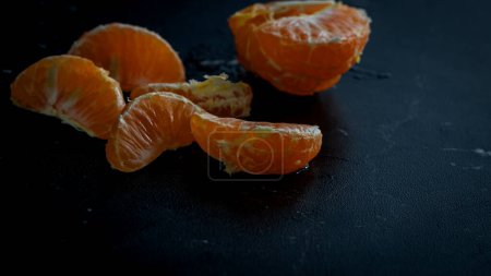 Sliced oranges on black background. Fresh fruit isolated on black