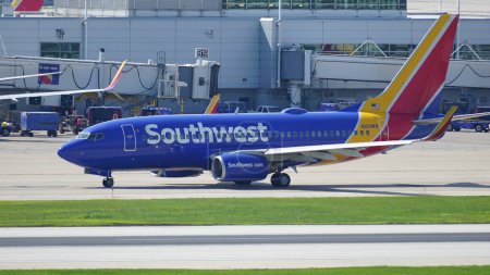Photo for Southwest Airlines Boeing 737 plane taxies on the runway after landing at Chicago Midway International Airport. - Royalty Free Image