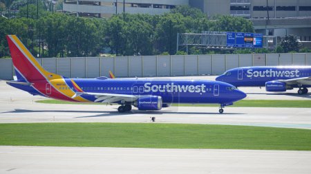 Photo for Southwest Airlines Boeing 737 plane taxies on the runway after landing at Chicago Midway International Airport. - Royalty Free Image