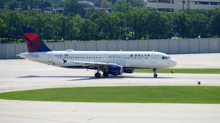 Photo for Delta Airlines Airbus A320 taxies on the runway after landing at Chicago Midway International Airport. - Royalty Free Image