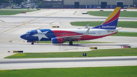 Photo for Southwest Airlines Boeing 737 with Lone Star One livery taxies on the runway after landing at Chicago Midway International Airport. - Royalty Free Image