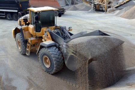 Wheel loader excavator unloading sand