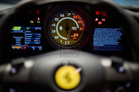 Photo for Tachometer and out of focus steering wheel Ferrari F8 Tributo Spider. View from the driving position. Katowice, Poland, 29.10.2019 - Royalty Free Image