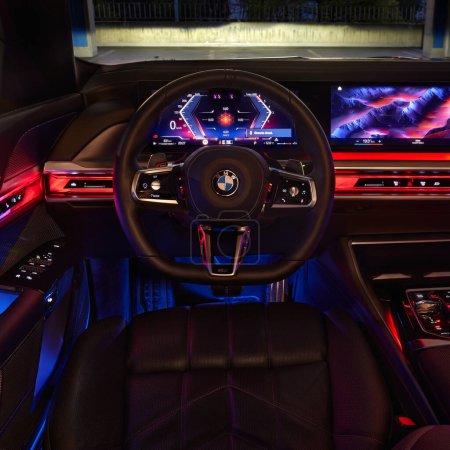 Photo for BMW 7 Series. Colorfully illuminated interior of the car, view centrally on the steering wheel from the driver's position. Model G70, a modern premium limousine. On sale from 2023. Poland, Katowice 03.05.2023 - Royalty Free Image