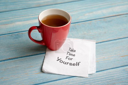 Take time for yourself, words on napkin next to a cup of coffee. Self care concept.