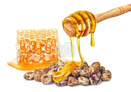 Photo for Dripping honey, honeycomb and tiger nuts isolated on white background - Royalty Free Image
