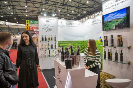 Photo for Kyiv, Ukraine - November 02, 2021: People visit Chateau Chizay Ukrainian winery booth at Wine and Spirits Exhibition, main event for wine and spirits market in Eastern Europe. - Royalty Free Image