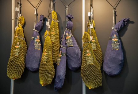 Photo for Kyiv, Ukraine - November 04, 2021: Aire Sano whole legs of jamon hang at Wine and Spirits Exhibition, the main event for the wine and spirits market in Eastern Europe. - Royalty Free Image