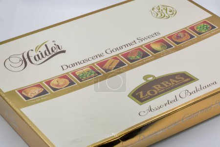Photo for Kyiv, Ukraine - June 02, 2021: Studio shoot of Zorbas Assorted Baklawa Haider Damascene Gourmet Sweets box closeup on white. Oriental sweets with almonds. - Royalty Free Image