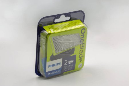 Kyiv, Ukraine - July 16, 2022: Studio shoot of Philips One Blade shaving razor spare parts closeup against white. Philips is a Dutch corporation that was founded in Eindhoven in 1891.